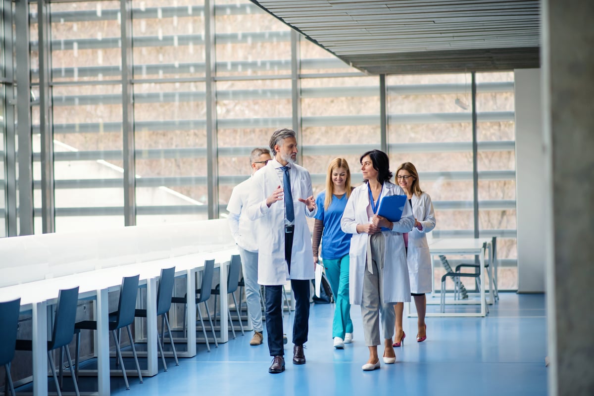 group-of-doctors-walking-in-corridor-on-medical-co-2024-10-18-16-13-11-utc